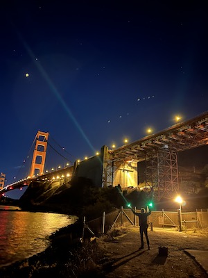 Two narrow beams pointing up near Golden Gate Bridge